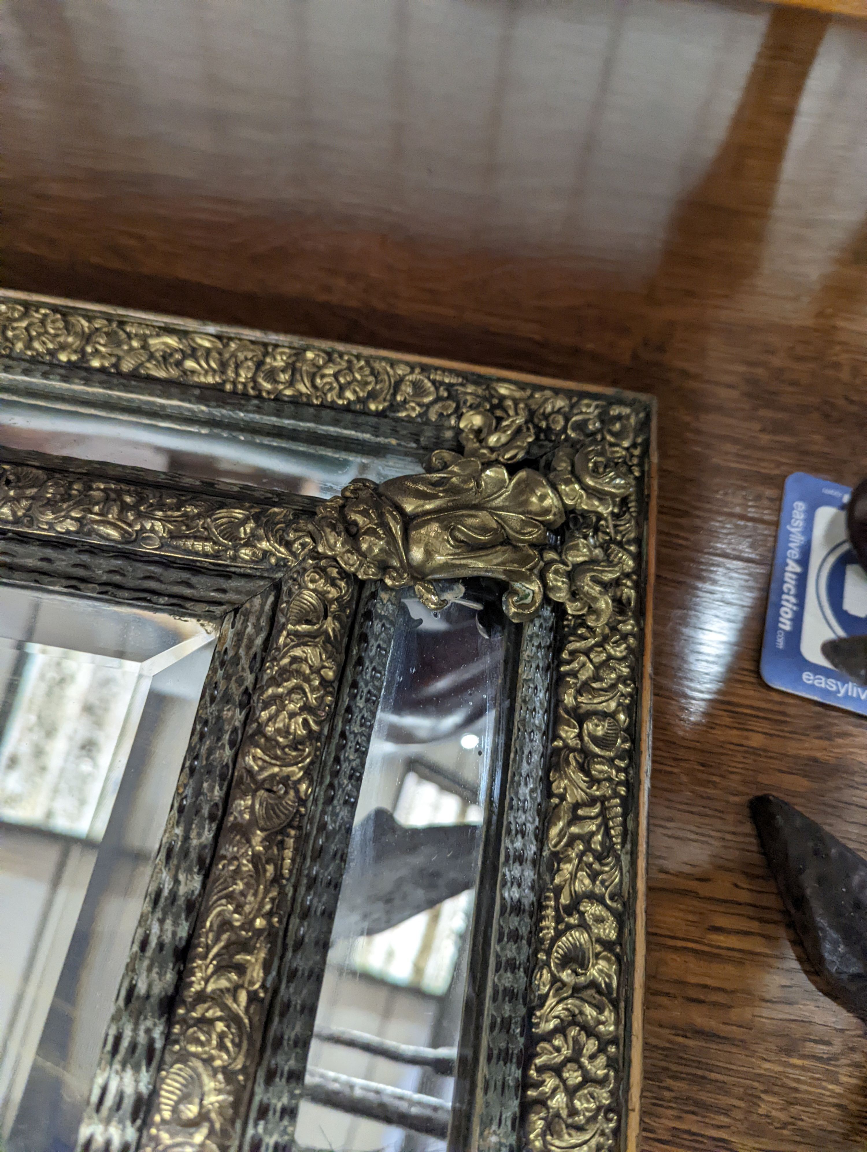 A 19th century Dutch embossed brass wall mirror, width 45cm, height 75cm